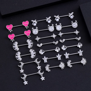 Set of surgical steel nipple rings with heart pendants, crystals and diverse designs