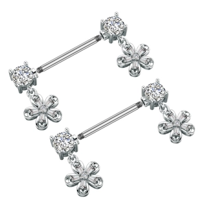 Detail showing two silver stainless steel nipple rings with zircon floral pendants