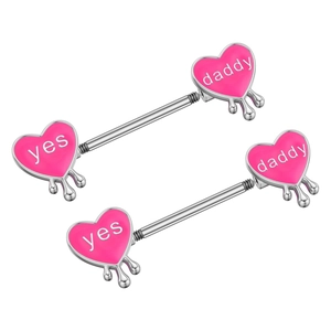Macro view of pink heart enamel nipple rings with dripping detail and Yes Daddy text