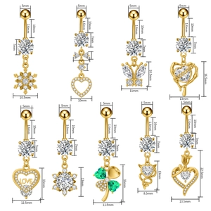 Detailed set of 9 golden belly button rings with butterfly and heart zircon pendants