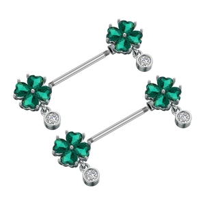 Detail of silver nipple rings with green heart clover design and clear zircon pendants