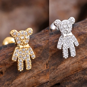 Detailed macro view of tiny bear stud earrings with sparkling cubic zirconia inlay
