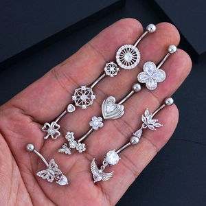 Detailed set of silver navel rings featuring butterfly, heart, and zircon wing designs