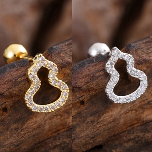 Detailed close-up of gold and silver hollow gourd stud earrings with cubic zirconia inlay