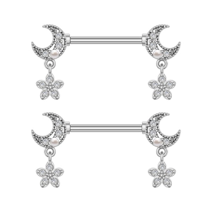 Macro detail of stainless steel nipple rings with moon and flower cubic zirconia dangles