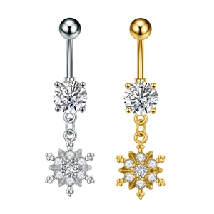 Detailed close-up of snowflake belly rings in gold and silver finish with sparkling zircons