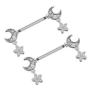Detailed close-up of stainless steel nipple barbells with moon and zircon flower charms