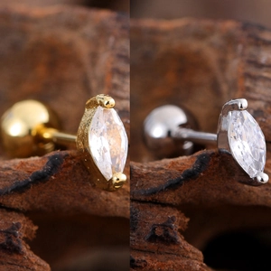 Macro detail of marquise-cut zircon screw-back earrings in gold and silver finish