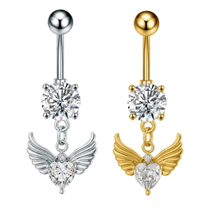 Macro detail of navel rings in gold and silver with heart zircon and angel wings designs