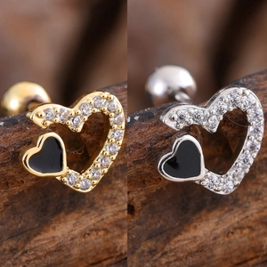 Macro view of minimalist double heart stud earrings with cubic zirconia and black enamel