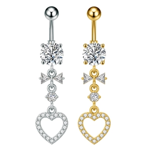 Detail of silver and gold belly rings with butterfly zircon and hollow heart pendant