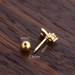 Macro view of gold butterfly stud earring showing precise 0.8x6x4mm size dimensions