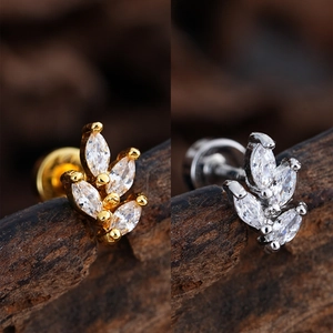 Macro detail of leaf-shaped labret studs with marquise zircons in gold and silver finish