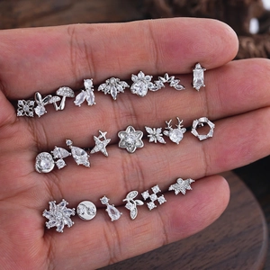 Minimalist stainless steel tragus earrings set with micro-pave cubic zirconia on hand