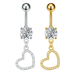 Detail of silver and gold heart belly rings featuring cubic zirconia and pavé setting