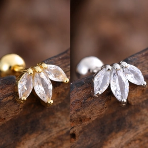 Detail of marquise-cut zircon stud earrings in gold and silver finish with leaf shape