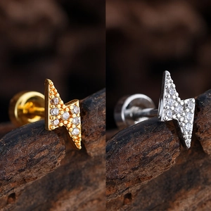 Detail of lightning bolt stud earrings with micro-pave cubic zirconia in gold and silver