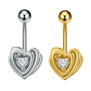 Macro detail of heart belly rings in gold and silver finish with heart-shaped zircon stones