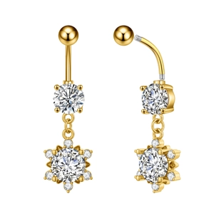 Macro detail of golden snowflake belly button ring with sparkling zircon and screw thread