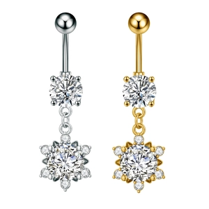 Detail of silver and gold belly button rings featuring sparkling snowflake zircon pendants