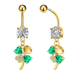 Detail of gold clover belly ring showing green heart stones and zircon inlay