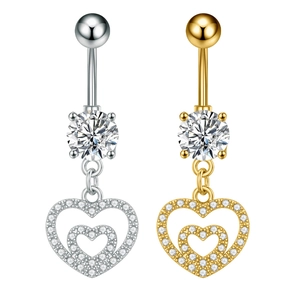 Close-up of gold and silver belly rings with dangling double heart zircon pendants