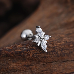 Macro shot of a silver floral ear stud with marquise and round cubic zirconia on wood