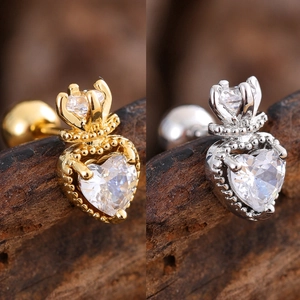 Macro shot of heart-shaped zircon ear studs with crown detail in gold and silver