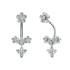 Macro detail of silver navel ring with zircon flower and hanging honey bee charm