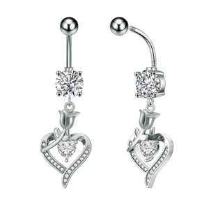 Macro view of silver butterfly navel ring with tulip ornament and heart-shaped crystal