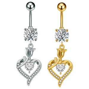 Detail of silver and gold belly rings with rose and heart zircon pendant charms