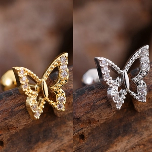 Macro view of gold and silver butterfly zirconia stud earrings with screw ball back closure