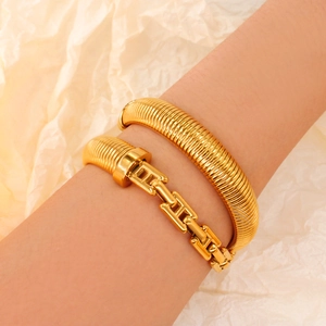 Minimalist gold titanium steel stretch bracelet with H-link design on female wrist