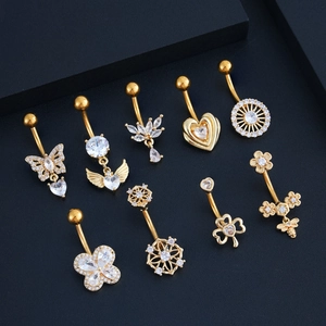 Set of nine golden navel rings with heart, butterfly and bee designs with cubic zirconia