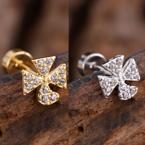 Macro view of micro-paved zircon cross labret studs in gold and silver steel finish