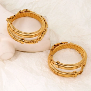 Close-up of gold stretch snake chain bracelets with H-shaped metal buckle on a white background