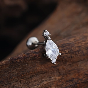 Macro side view of silver stud earring with drop-cut zircon and ball-back closure