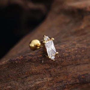 Macro view of gold stainless steel stud earring featuring square cubic zirconia and ball back