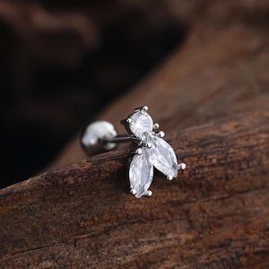 Macro detail of stainless steel tragus stud with three marquise and round zircon stones