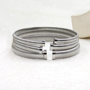 Detail of silver spring spiral cuff bracelets set with polished finish and metal end caps