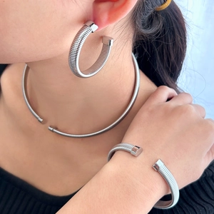 Modern silver hoop jewelry set with textured coil necklace, bracelet and earrings