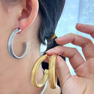 Chunky C-shaped hoop earrings with tubogas spiral texture in gold and silver finish