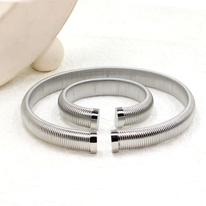 Detail view of silver threaded stainless steel cuff bracelets with smooth cylindrical ends