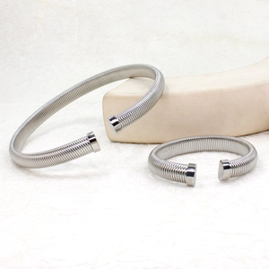 Detail view of flexible silver stainless steel spring bangles with polished ends