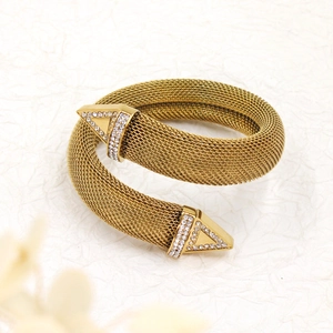 Detailed macro view of 18K gold plated mesh wrap bracelet with sparkling crystal triangles