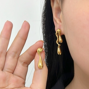 Polished gold liquid metal asymmetric lava teardrop earrings for a modern minimalist look