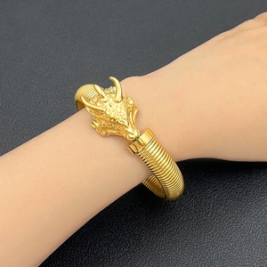 Detalle de brazalete de cabeza de dragón en oro de 18K con escamas y textura de metal