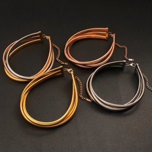 Detail of multi-layer metallic neck collars with lobster clasps in gold silver and rose gold