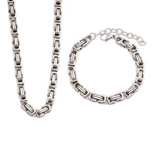 Detailed macro view of bright silver Byzantine chain necklace and bracelet jewelry set