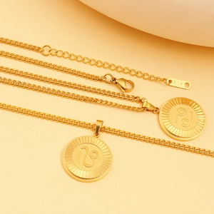 Detailed macro of gold zodiac pendant necklace featuring lobster clasp and K18 tag